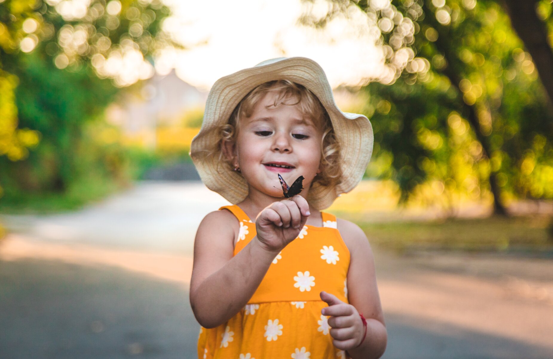 little girl holding butterfly